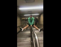 Guy slides down stairs railing