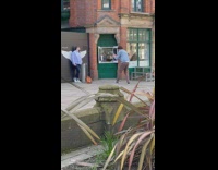 Woman poses in front of the wall with wings on it