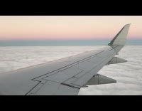 View plane wing clouds and airport landing