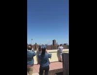 people on roof wait for airplanes fly over