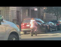 Woman wear winter clothes and drive scooter NYC 