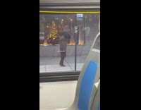 Man brown jacket dance on street bus