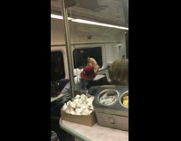 Two People Arm Wrestle in Subway
