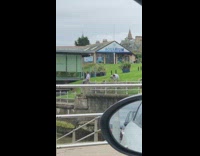 Woman white top sit rock aquarium pictorial