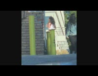 Girl poses outside brick building friend selfie 