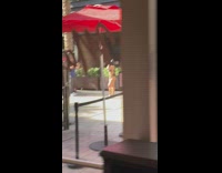 Woman in bikini with heels and a cat mask on the walkway