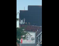 Two girls dance rooftop black building leggings 