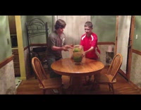 Rubber bands cause watermelon to shoot at light fixture