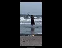 Collab Kook Of The Day - Kid waves wood stick around beach shore