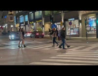 Two women dress model walk pedestrian lane
