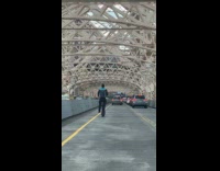 Amazon delivery man ride scooter on bridge