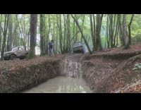 Dirt truck falls upside down on mud pond