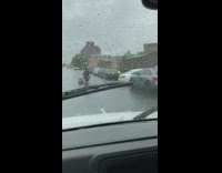 Two guys motorcycle red lawn mower rain 