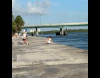 Woman white top dances near the river