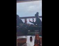 Girls tap glass drink near window bottle