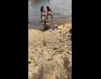 Two women dance twerk beach pink onesie