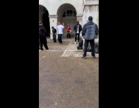 Three people tiktok dances near Royal Guard