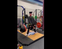 Guy cap and gown deadlift for graduation picture