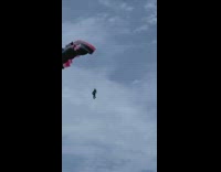 Black red toy parachute flies beach martin