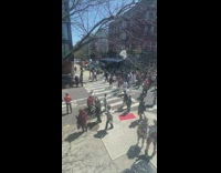 Guy wearing jesus costume carries cross 