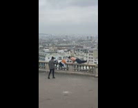 Man shirtless exercise push ups railings building