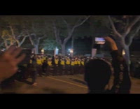 People Protest at Night as Police form Blockade