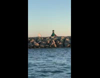 Woman medusa green dress jetty beach sunset