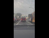 Man berates school bus driver at a traffic light 