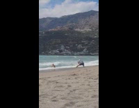 Collab IITW - Woman in bikini poses at beach shore