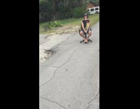 Guy gets pulled by car on rolling desk chair on street and falls