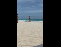 Girl black bikini hold water glass beach