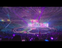 Fans wave light stick rainbow color during concert