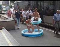 Couple blocks sidewalk for swim photoshoot 
