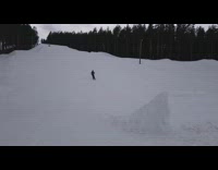 Skier does a big backflip off ski ramp and falls backwards on their leg