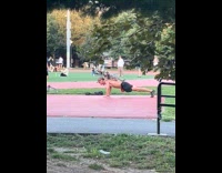 Dog rides man back while doing pushup