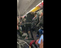 Contortionist guy bends his arms backwards and dances on subway train