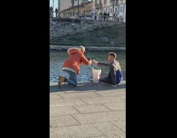 Orange jacket photographs food over water