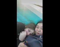 Two girls stuck on inflatable pool in middle of lake 