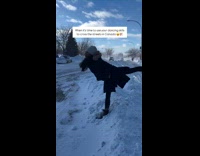 Ballerina kicks legs over to step over snow 