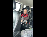 Young boy in car try to whistle