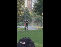 Man ride onewheel board hold toy gun wheel park