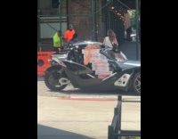 Autocycle with man carries lots of pizza