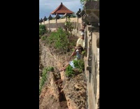 two women brown fence cliff 