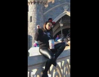Girl posing with plastic container Disneyland castle