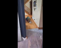 Guy lays down while riding hoverboard legs drag on floor behind him