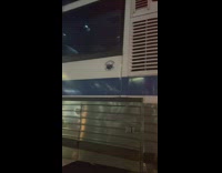 Guy holds onto the back of MTA bus 