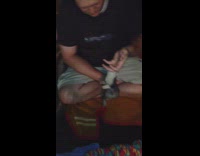 Ferret hanging from hand and spinning its body 