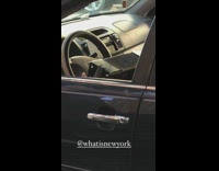 Guy sitting in car plays accordion 