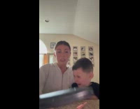 Mom and kid experimenting with popcorn and hair iron