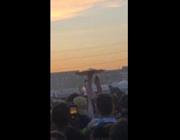 Guy spins pizza dough around on his finger during an outdoor concert set